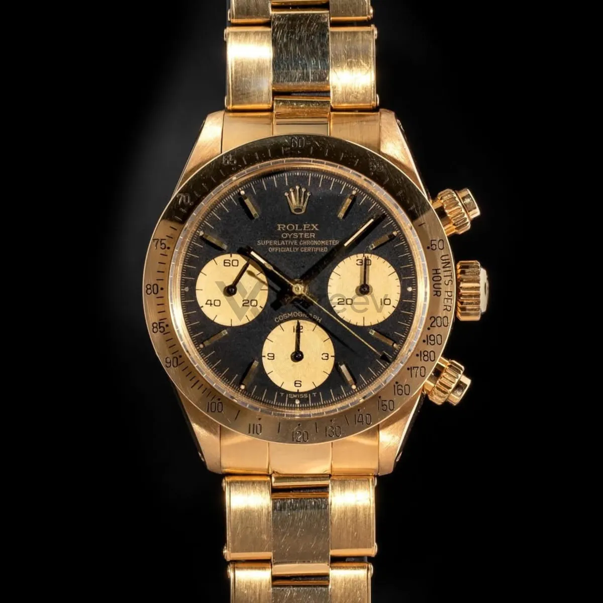 Sample photo 1, Dial Front: the black dial of a gold Rolex Daytona, photographed straight on